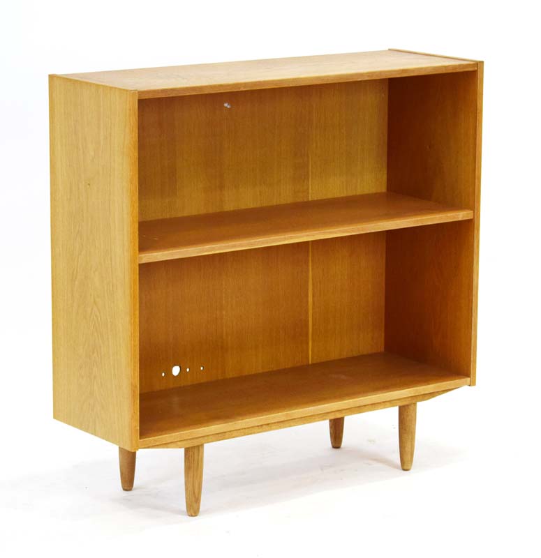 A 1960's oak open-fronted bookcase with one adjustable shelf on circular legs, w.