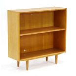 A 1960's oak open-fronted bookcase with one adjustable shelf on circular legs, w.