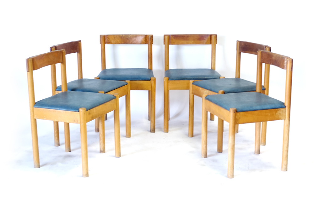 A set of six 1960's pine and blue vinyl dining chairs with unusual backs and joints