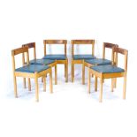 A set of six 1960's pine and blue vinyl dining chairs with unusual backs and joints