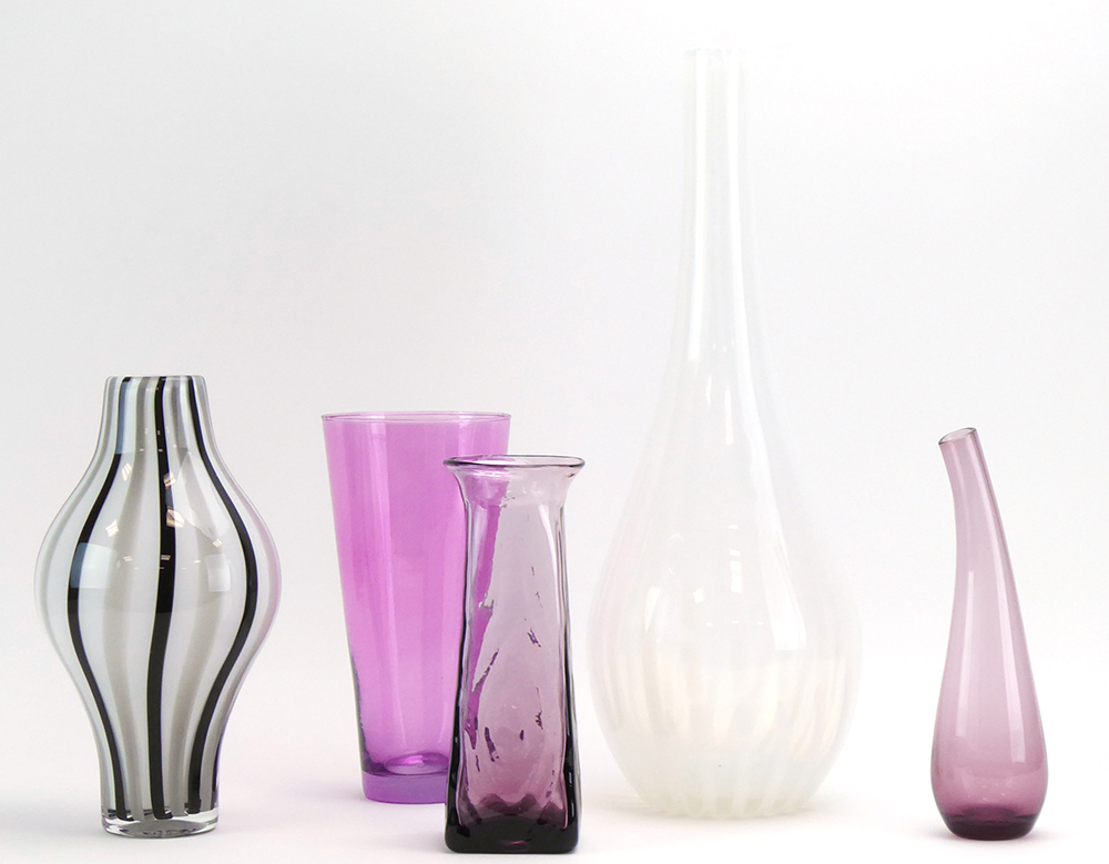 A group of glass including a Blenko amethyst vase with a curved neck,