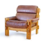 A 1960/70's rustic pine framed lounge armchair with brown leather upholstery CONDITION