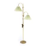 A 1960/70's brass finished twin-spot standard lamp with pleated shades,