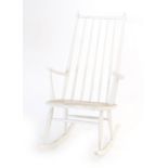 A white painted spindle back rocking chair