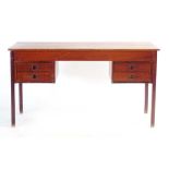 A 1960's Danish teak and crossbanded desk, the four drawers with moulded integral handles,