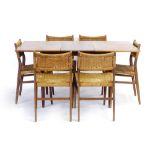 A 1960's dining suite including six teak and seagrass chairs and a walnut finished extending table,