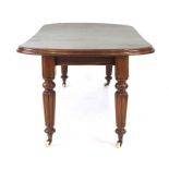 A Victorian mahogany drawer leaf extending dining table on tapered reeded legs,