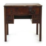 A Georgian mahogany serpentine fronted lowboy with one long drawer and four smaller drawers,