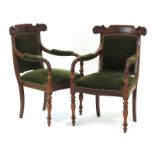 A pair of 19th century mahogany and upholstered armchairs on turned front legs