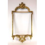 A Classical-type wall mirror with a gilt metal frame surmounted by a scrolled pediment,