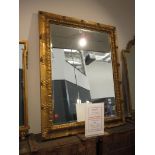 A 20th century wall mirror, the rectangular bevelled plate within a gilt moulded frame,