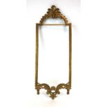 A near pair of Classical-type gilt-metal wall mirror frames surmounted by scrolled pediments,