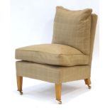 A contemporary 'Marlborough' lounge chair upholstered in caramel loosely chequered fabric,