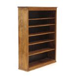 An early 20th century oak open-fronted adjustable bookcase on a plinth base, w.