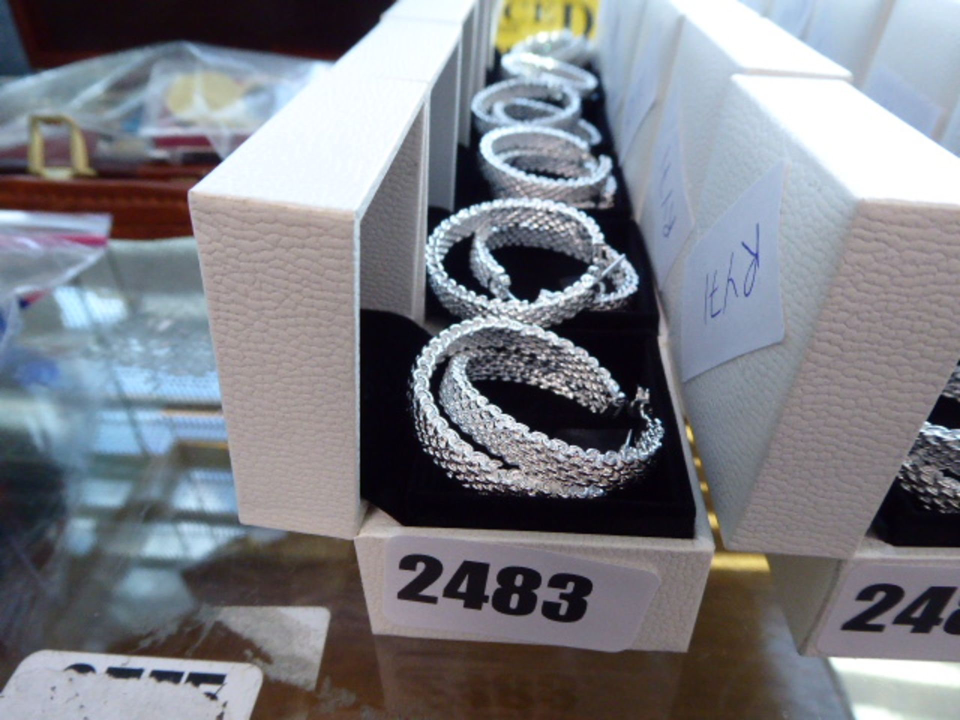6 white metal hoop earings with Pandora boxes