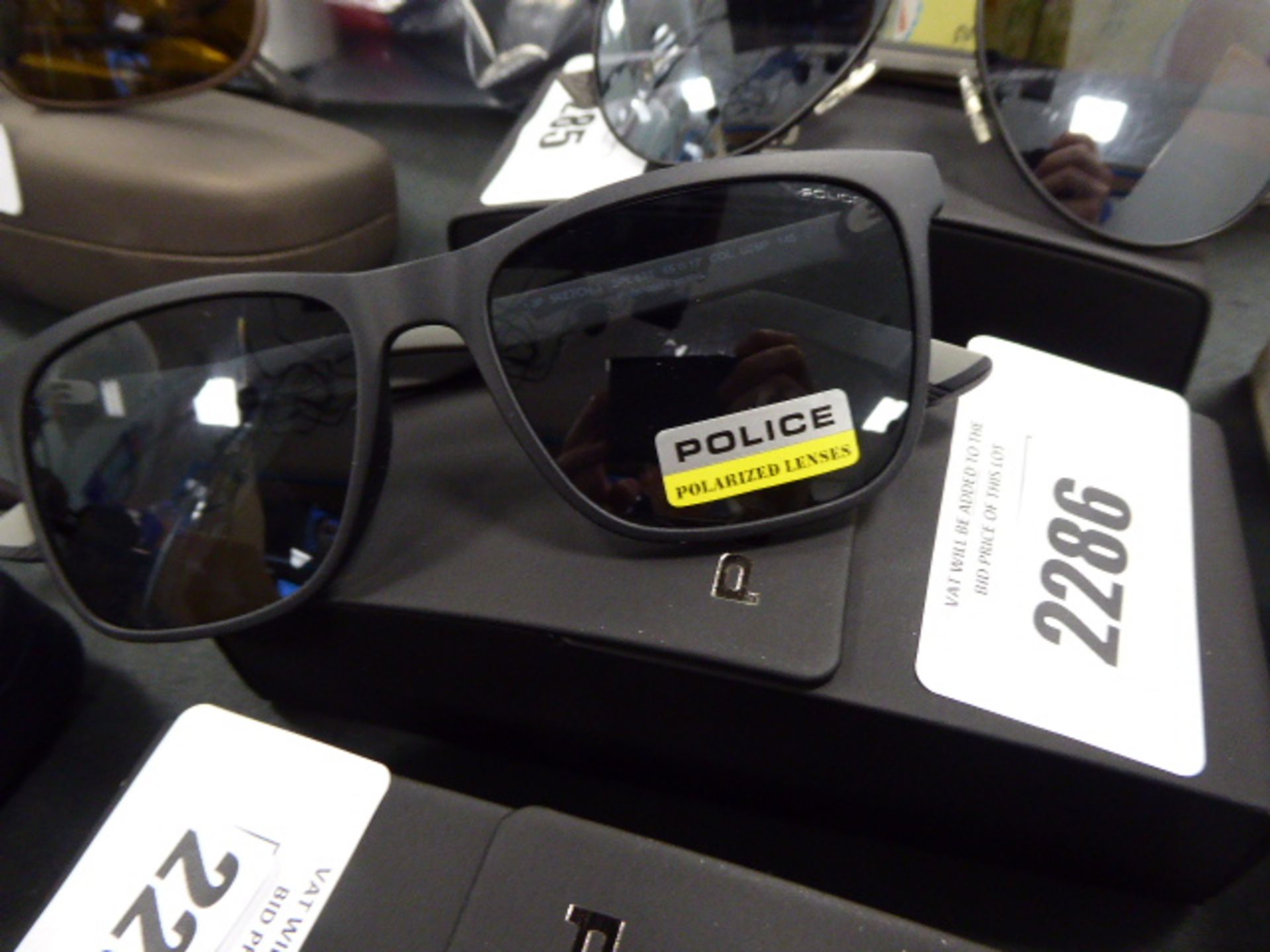 A pair of police sunglasses with hardcase
