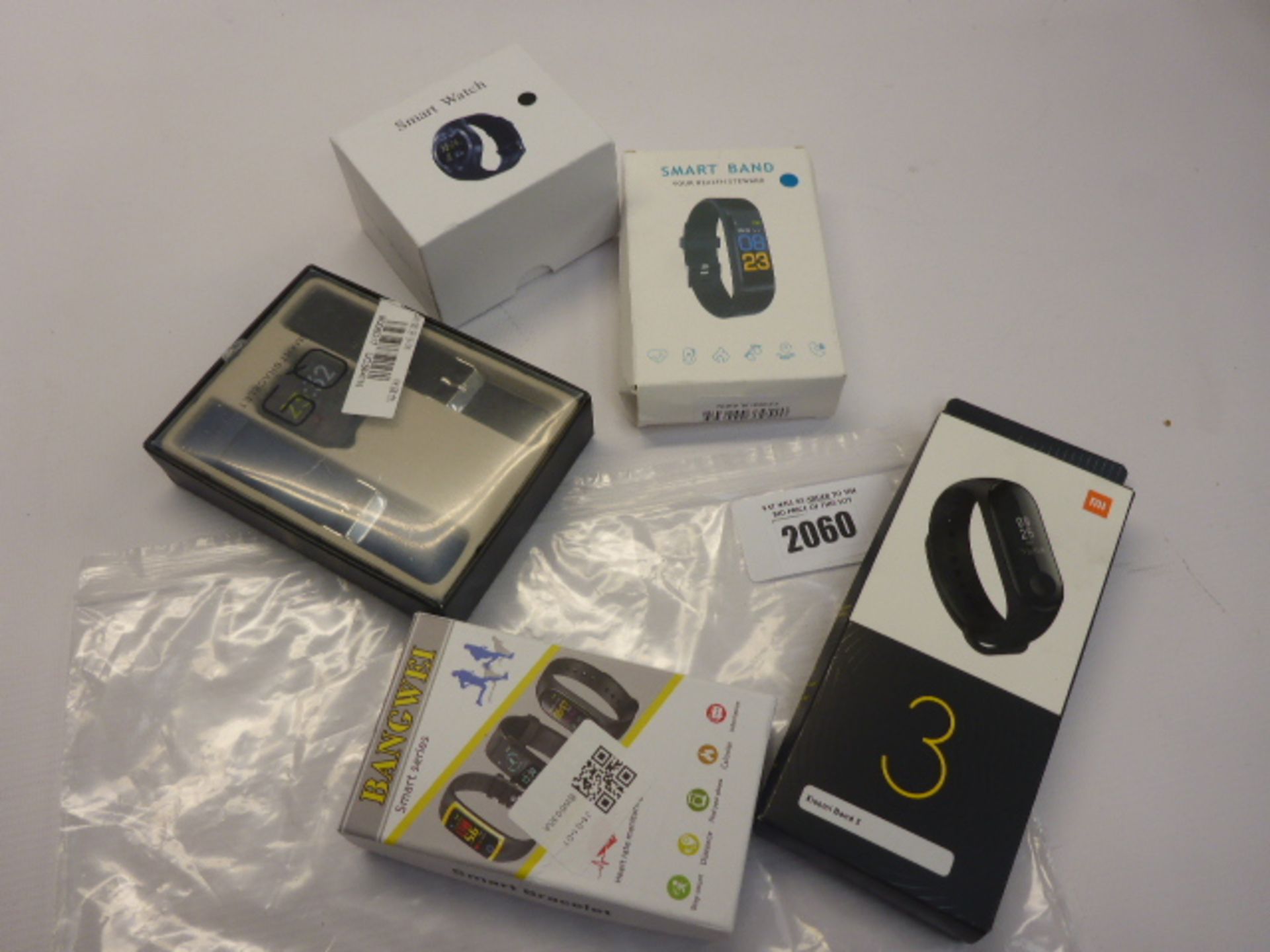 Bag of Five smart watches and fitness trackers.