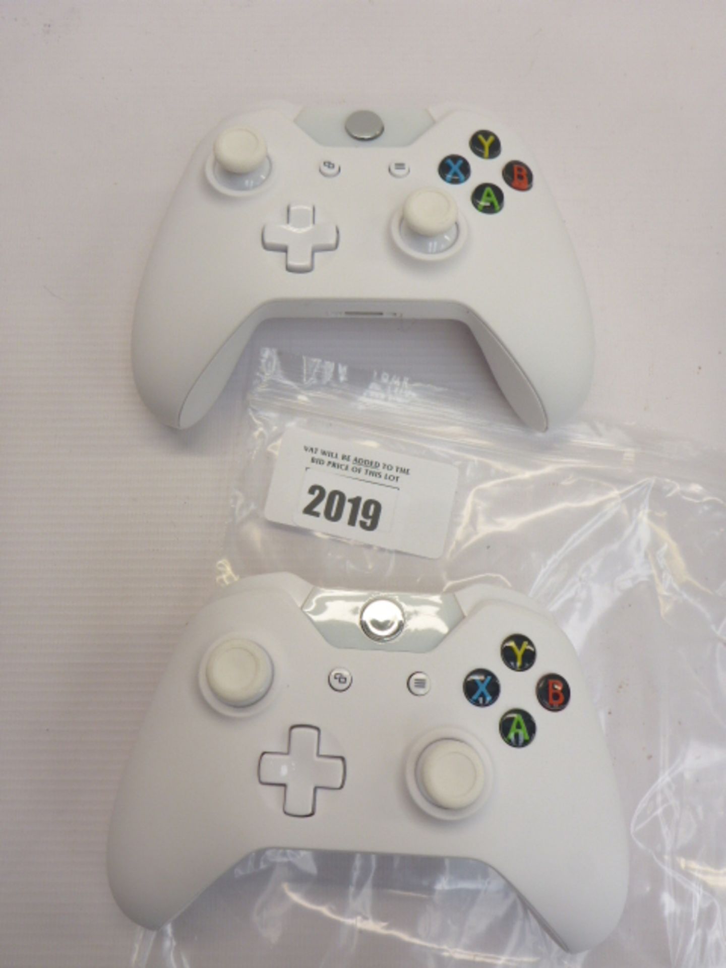 Two White Xbox One Controllers.