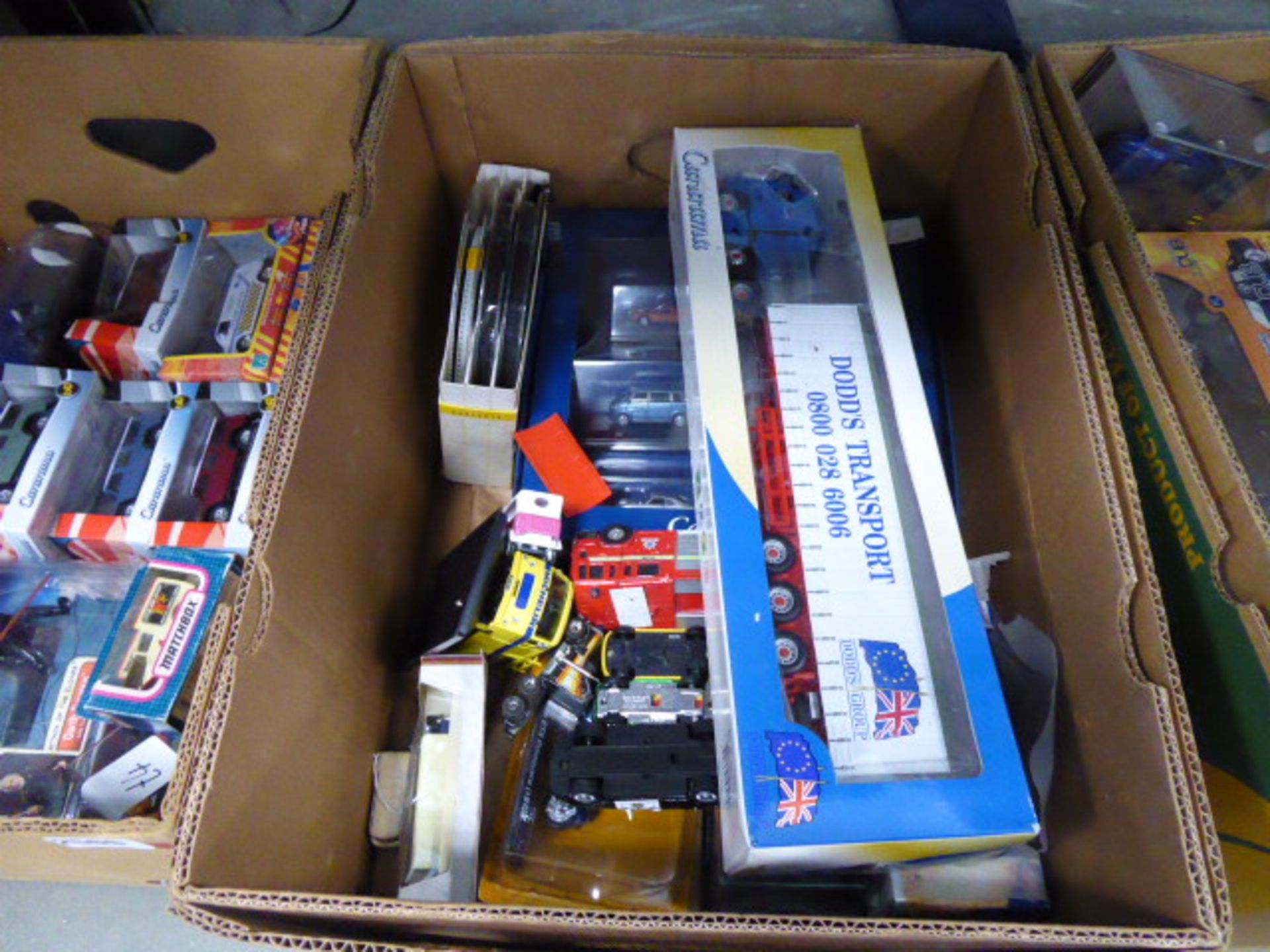 A box containing various die cast vehicles