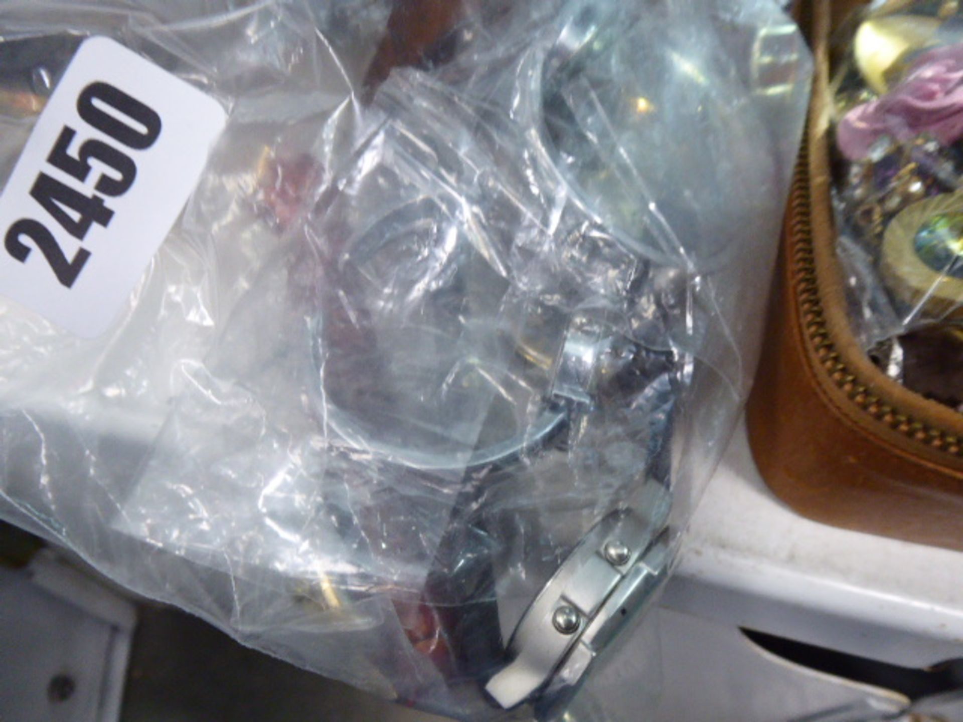 A bag containing loose wristwatches