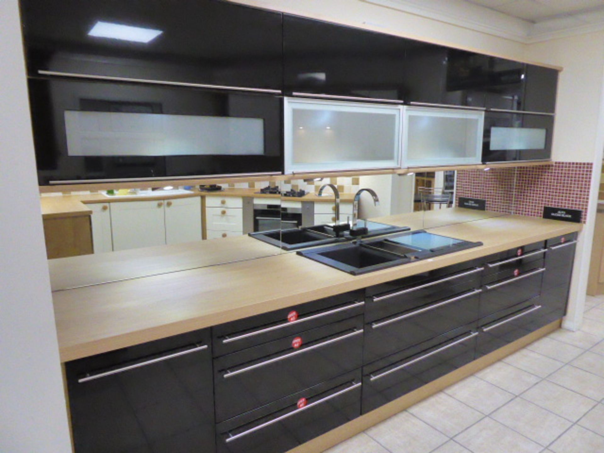 Alto gloss black galley kitchen measuring 370cm long with light oak wood laminate worktops. With a 1