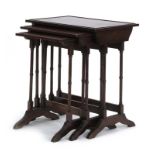 A nest of three Regency-style mahogany occasional tables on slender turned legs