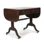 A 19th century mahogany and crossbanded sofa table with two frieze drawers on reeded supports with