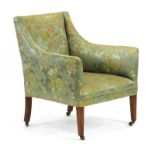 A late 19th century and later upholstered armchair with exposed mahogany legs on castors