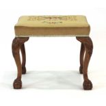 A Queen Anne-style walnut and upholstered stool on cabriole legs with acanthus leaf caps and ball