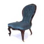 A Victorian mahogany and button upholstered balloon back chair on scrolled front legs with castors