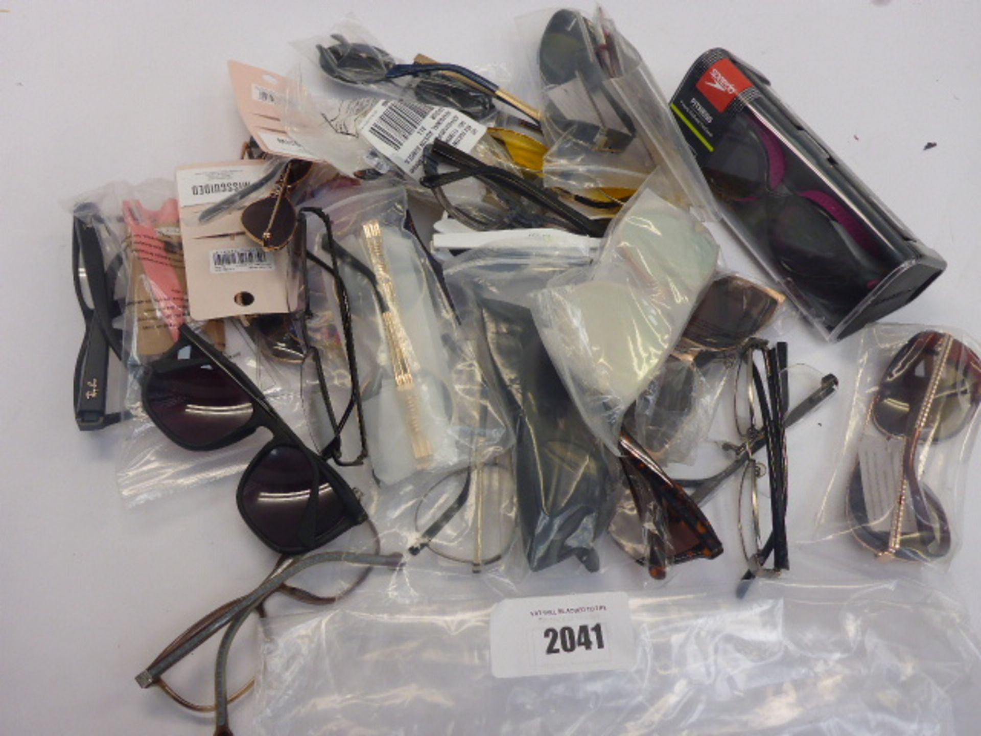 Bag containing quantity of various sunglasses and reading glasses