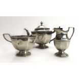 An early 20th century silver three piece tea service of canted vase shaped form, Mappin & Webb,