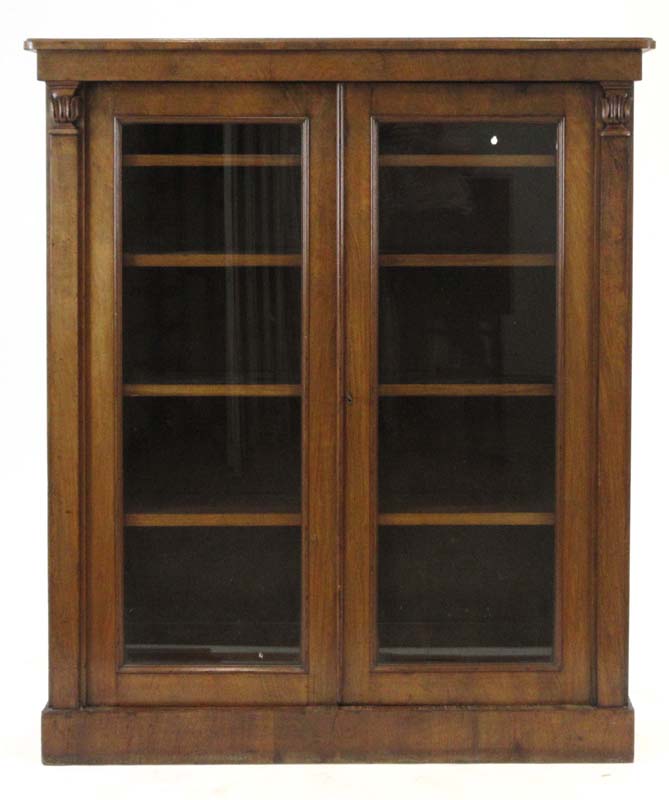 A Victorian walnut bookcase with two glazed doors, on a plinth base, w.