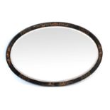 A black lacquered oval bevelled mirror decorated in the chinoiserie manner,