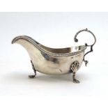 A late Victorian silver sauce boat with leaf capped c-scroll handle on three hoof feet, maker GMJ,