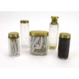 A set of five Victorian glass bottles, each with an 18ct yellow gold mount, maker TJ, London 1872,