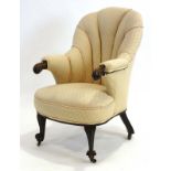 A 19th century mahogany framed armchair with later upholstery on scrolled front legs with castors