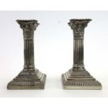A pair of Edwardian silver candlesticks of Corinthian column form, maker HE Ltd.