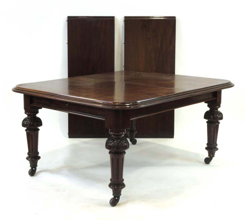 A 19th century mahogany extending dining table with two fitted leaves on turned legs with castors,