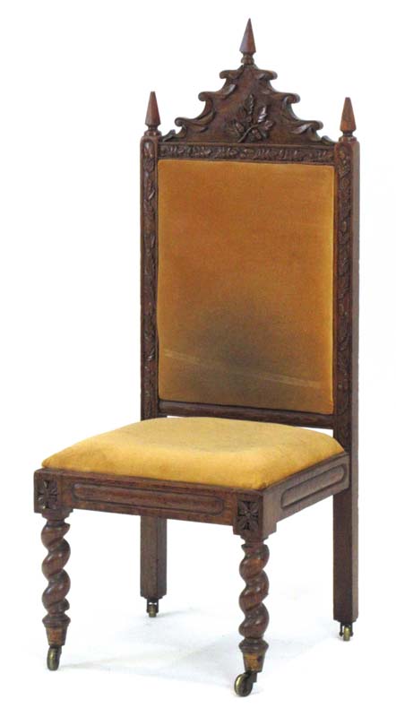 A Victorian oak and upholstered hall chair with a Gothic Revival pediment,