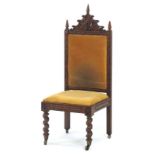 A Victorian oak and upholstered hall chair with a Gothic Revival pediment,