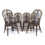 A set of six 20th century beech and elm wheelback dining chairs including two Windsor carvers