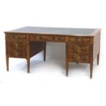 A 20th century walnut twin pedestal partner's desk,