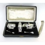 A cased silver condiments set comprising salt, pepper, mustard and two spoons, maker BS,