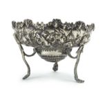 A Victorian silver repousse decorated dish raised on three outswept feet, maker WC, London 1886, d.