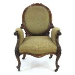 A 19th century rosewood and upholstered armchair with scrolled arms and cabriole front legs with