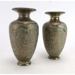 A pair of Middle Eastern metalware vases of ovoid form relief decorated with exotic birds and