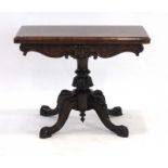 A William IV rosewood games table, the folding surface over a scrolled apron,
