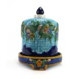 A majolica cheese dome and base decorated with floral sprays, h.