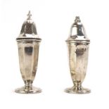 A silver salt and pepper of vase shaped form, maker EV, Sheffield 1946, h. 10.